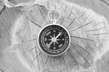 Classic navigation compass on natural background as symbol of tourism with compass, travel with...