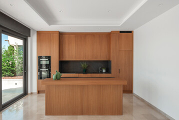 Modern kitchen with  island in browns.