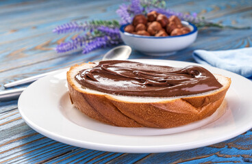 Spreading hazelnut cream on bread, chocolate nut butter
