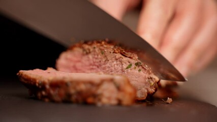 Woman cuts juicy duck fillet with knife.