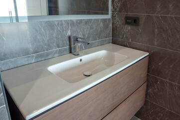 Fototapeta premium Modern white washbasin with mixer tap in bathroom.
