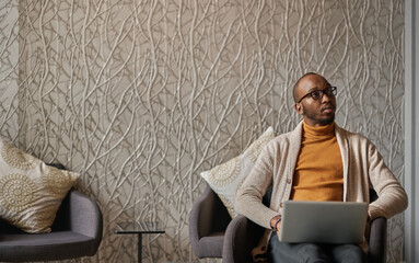 Black african entrepreneur working on laptop in coworking office space