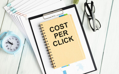 CPC Cost Per Click written in notebook on wooden table