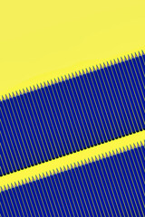 Pattern of blue pencils at yellow background