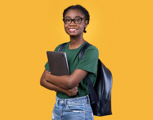 Smiling African Female Student Holding Laptop Posing On Yellow Background