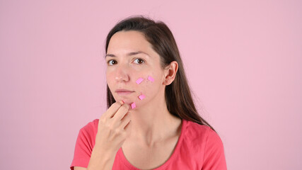Stickers on problem skin, on a pink background