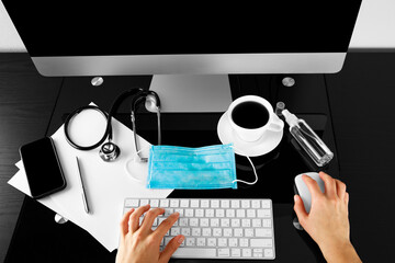 disinfection of a computer keyboard with an antiseptic. Disinfecting workplace concept.