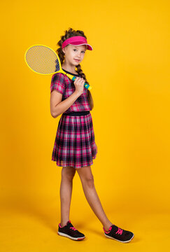 healthy and active lifestyle. full of energy. happy childhood. kid in cap hold racket. child with racquet. teen girl do sport training. dedicated to fitness. tennis or badminton player