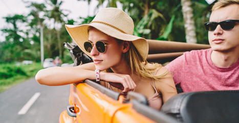 Tranquil couple travelling in convertible