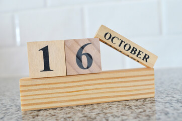 October 16, Cover design with number cube on a white background and granite table.