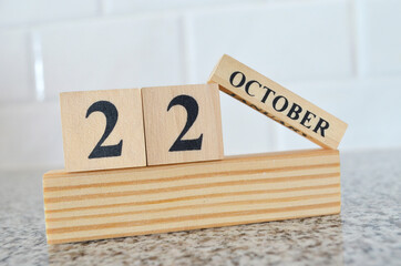 October 22, Cover design with number cube on a white background and granite table.