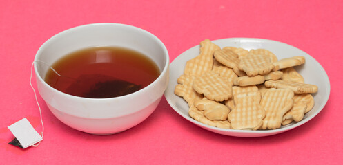 Tea biscuits on a pink background.
