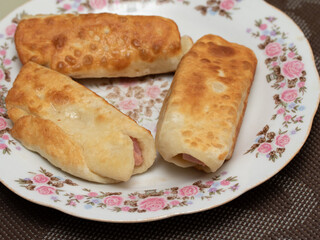 Sausage in dough fried on a breakfast plate.