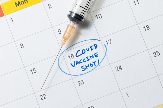 Doctor reminder covid-19 vaccine shot in calendar with syringe, medicine and vaccine concept