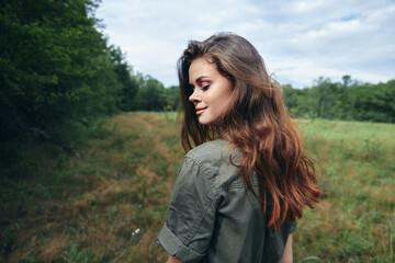 Fototapeta premium Woman in the meadow Eyes closed looking towards the fresh air of lifestyle freedom 