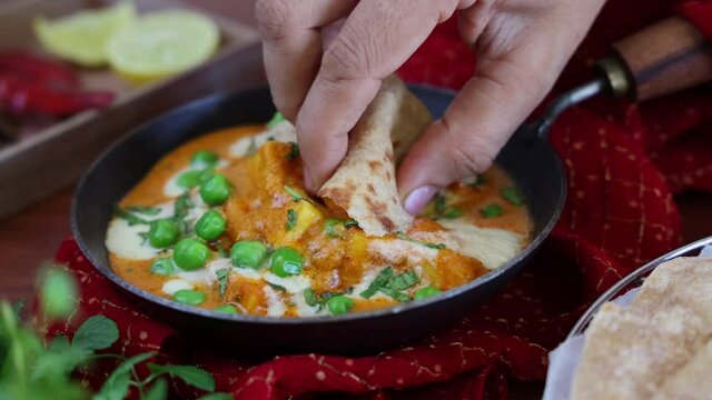 Matar Paneer curry recipe made using cottage cheese, green peas, 4K slow motion video, footage Kerala, Delhi, India. Eating with hand North Indian veg curry side dish for Roti, Chapati, naan, Pulao
