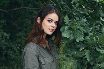 Woman in the forest Attractive look green leaves lifestyle background summer 