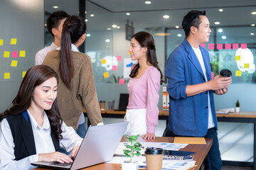 Group of Business putting forward suggestions to colleagues. Startup business team on meeting in modern bright office.They smiling and enjoying each others.