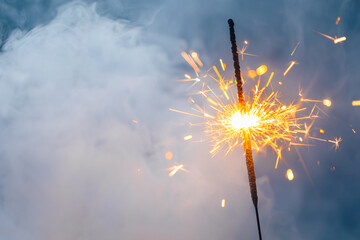 fire sparkler in dense smoke, abstract Christmas firework background