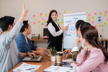 Portrait businesspeople standing by white board and giving presentation to colleagues during meeting in conference room. explaining something meeting to colleagues. Project results.
