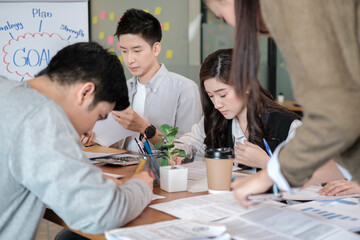Group of young business people in smart casual wear working together in office. Team of work.