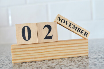 November 2, Cover design with number cube on a white background and granite table.
