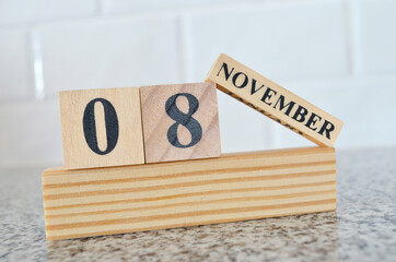November 8, Cover design with number cube on a white background and granite table.