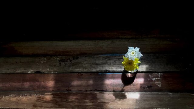 Beautiful Chrysanthemum morifolium Ramat flowers in small glass bottle on old wood table top,natural dimly light,free space for your text design,selective focus.