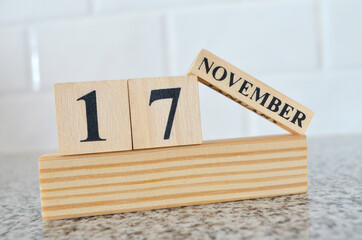 November 17, Cover design with number cube on a white background and granite table.