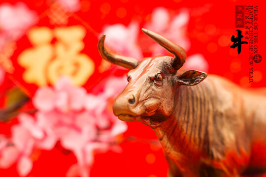 Tradition Chinese golden ox statue,2021 is year of the ox,Chinese characters translation: "ox".rightside chinese wording and seal mean:Chinese calendar for the year.