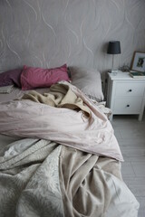 Bed with duvet and blanket in the bedroom