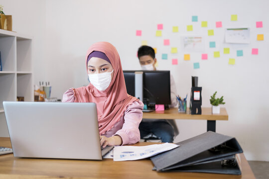 Saudi Arab Woman Work In Socially Spaced Offices. Social Distance Wear A Mask Prevent Spread From Coronavirus. Work Like A Professional.