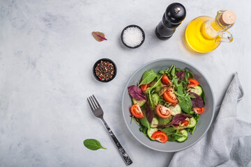 Healthy fresh salad of vegetable cucumber, tomato, spinach, arugula