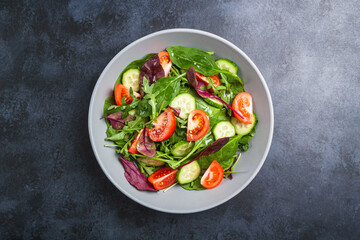 Healthy fresh salad of vegetable cucumber, tomato, spinach, arugula
