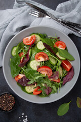 Healthy fresh salad of vegetable cucumber, tomato, spinach, arugula