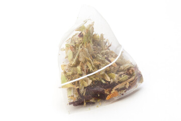 
Unused pyramid tea bag with a tag on a white background, top view. Place for text