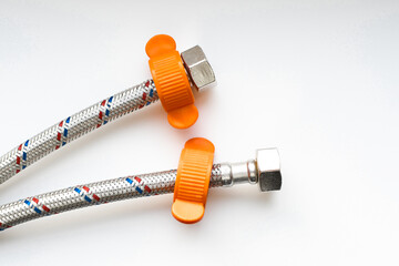Flexible connecting water hose. Nylon plastic braided plumbing hose. Isolated on white background