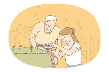 Houseplants and gardening concept. Young smiling girl and grandfather cutting green plant sprouts with special scissors for better growing and taking care of small garden 