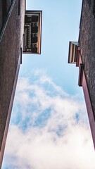 clouds in sky between buildings