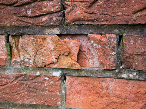 Domestic brickwork showing facing loss and damage due to water ingress and frost.