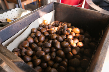 roasted chestnuts in wooden bucket