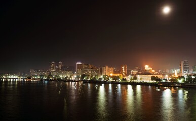Fototapeta na wymiar Big Dnieper river in the huge night bright city of Dnipropetrovsk in Ukraine