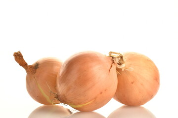 Three round aromatic onions, close-up, isolated on white.