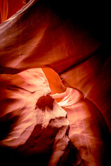 Red sandstone textures of Antelope Canyon, that resembles a face, and is the most-visited and most photographed slot canyon in the American Southwest located on Navajo land near Page, Arizona. USA. 