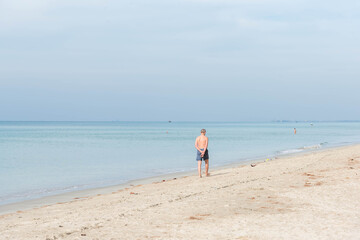Vintage and retro toning of tropical beach with blue sky and clear sea which including of a wooden umbrella and chair in sunrise time with vintage retro tone. Vacation time as concept.