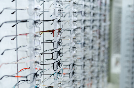 Showcase with spectacles in modern ophthalmic store. Stand with glasses in the store of optics. Closeup.