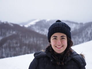 Fototapeta na wymiar portrait of a young woman with a snowed background