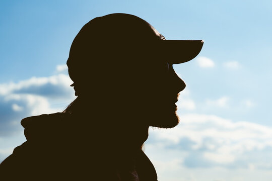 silhouette of a man in a cap