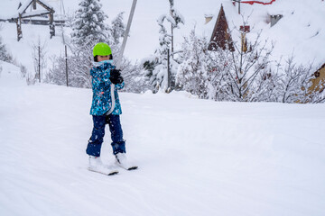 Fototapeta na wymiar Blurred focus background. A girl lifting on the ski drag lift rope in blue sport outfit on the ski resort mountain do a ski lesson during a snowfall. Ski resort in french mountain. High quality photo