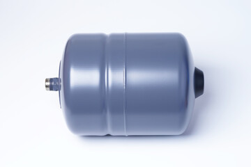 A vertical hydraulic tank lies on a white background. Hydroaccumulator for water supply, gray-blue.